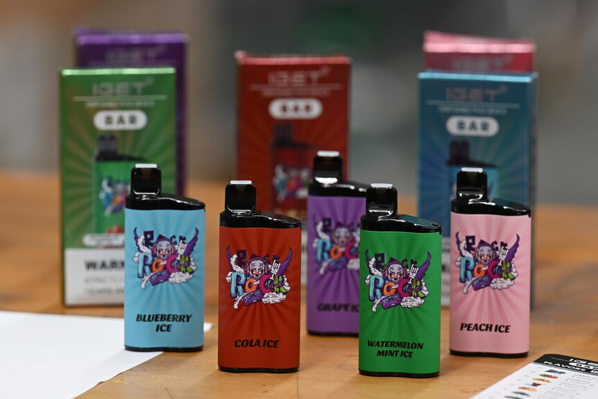 An array of brightly coloured vapes sit on a table, with cartoon skulls and ROCK text