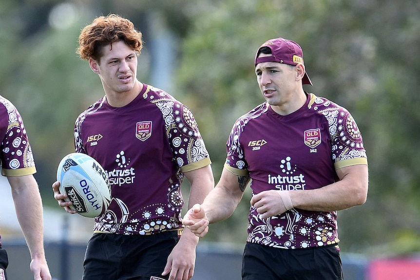 Kalyn Ponga looks on, as Billy Slater speaks at a Queensland State of Origin training session.