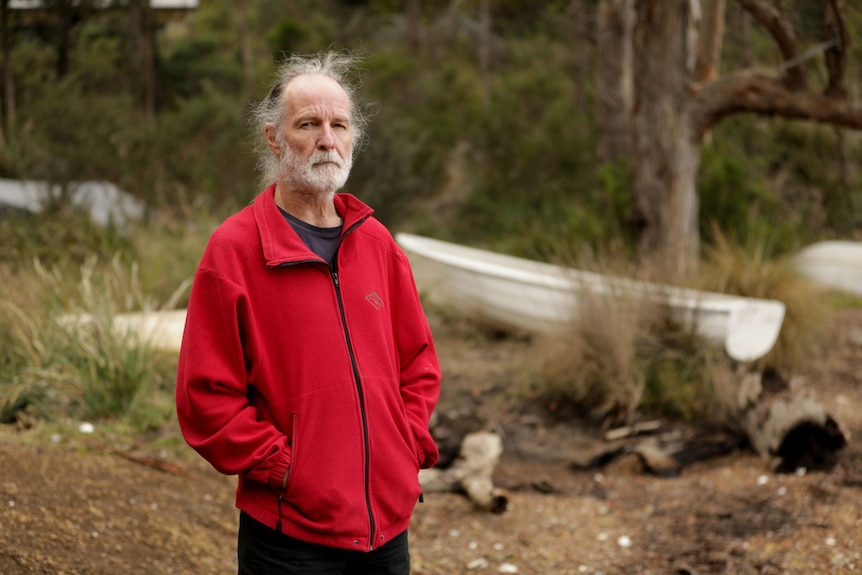 A grey haired man in a red jumper in natural bay