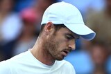 A British male tennis player looks at his racquet during a match at the Australian Open.