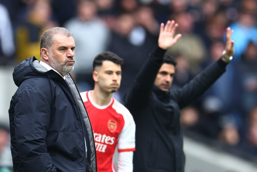 Ange Postecoglou stands in front of an Arsenal bench change