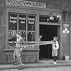 Charles Chaplin and John Rand in The Pawnshop (1916)