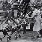Judy Garland, Charles Becker, Harry Earles, Jackie Gerlich, Jerry Maren, and Meinhardt Raabe in The Wizard of Oz (1939)
