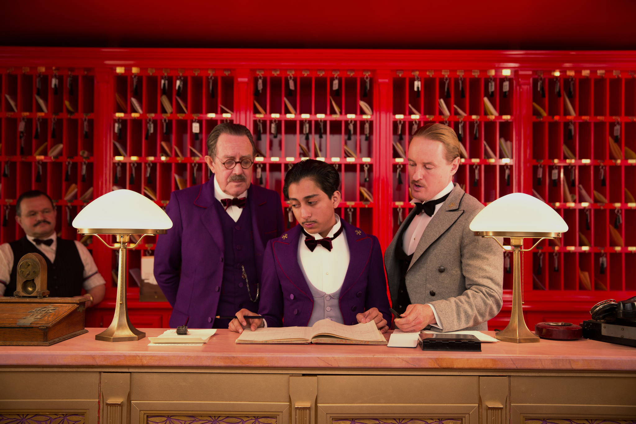 Owen Wilson, Larry Pine, and Tony Revolori in The Grand Budapest Hotel (2014)