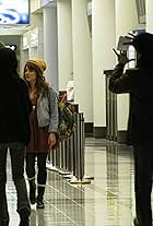 John Burgess directing Shane McRae and Aubrey Dollar at O'Hare International Airport