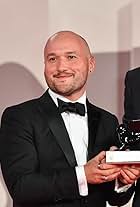 VENICE, ITALY - SEPTEMBER 11: Adam Butterfield poses with Orizzonti Award for the Best Short Film for "Los Huesos" at the awards winner photocall during the 78th Venice International Film Festival on September 11, 2021 in Venice, Italy.