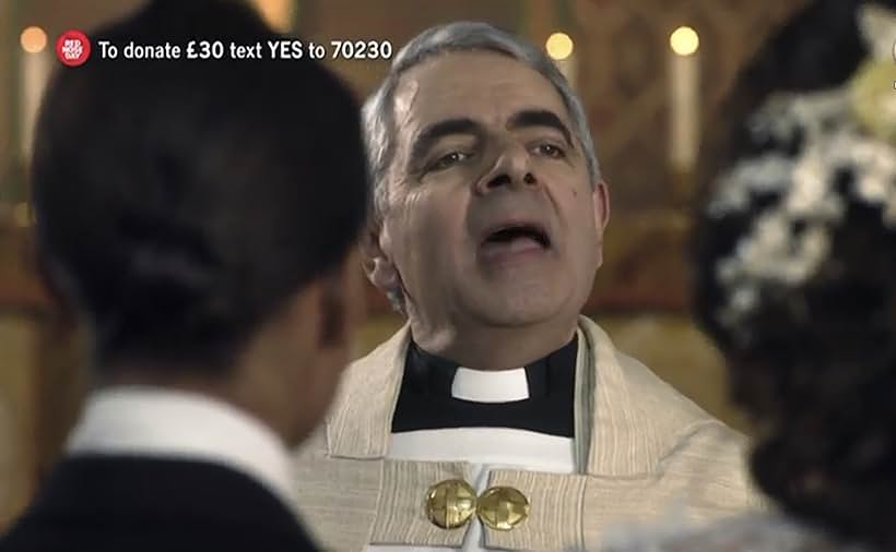 Rowan Atkinson and Alicia Vikander in One Red Nose and a Wedding (2019)