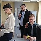 Left to right: Catherine (Mitzi Akaha), Bill the Billionaire (Yaron Urbas), and Joe (Travis Kent) in the office scene in Burning Man: The Musical.