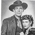 Barbara Britton and Rod Cameron in Ride the Man Down (1952)