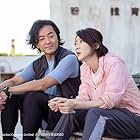 Ekin Cheng and Catherine Chau in Life Must Go On (2022)