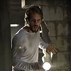 George Lutz (RYAN REYNOLDS) discovers a secret room in the basement in THE AMITYVILLE HORROR.