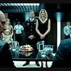 Ascension still photo. Councilman Davis (Carlo Mestroni), Captain Denninger (Brian Van Holt), Viondra (Tricia Helfer), and Councilman Rose (Al Sapienza).