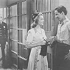 Bobby Jordan, Lew Kelly, and Elyse Knox in Keep 'Em Slugging (1943)