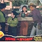 Gene Autry, Smiley Burnette, Fay McKenzie, and Joe Strauch Jr. in Home in Wyomin' (1942)