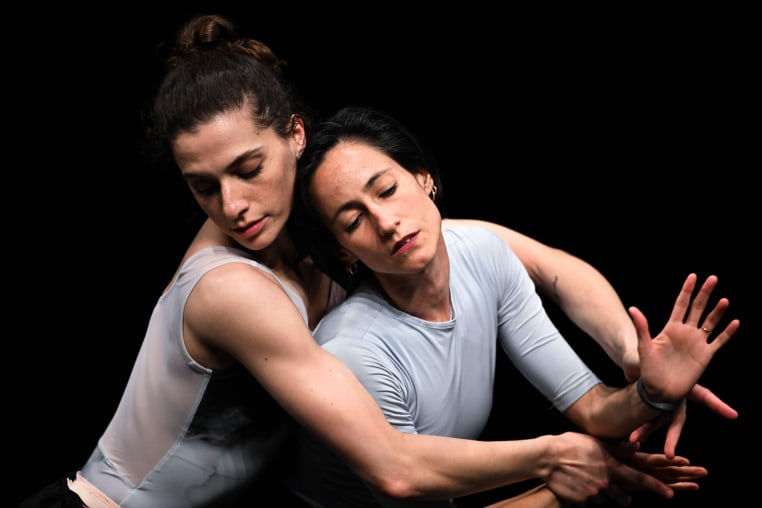 Lauren Flower, left, cradles Annia Hidalgo, while dancing together