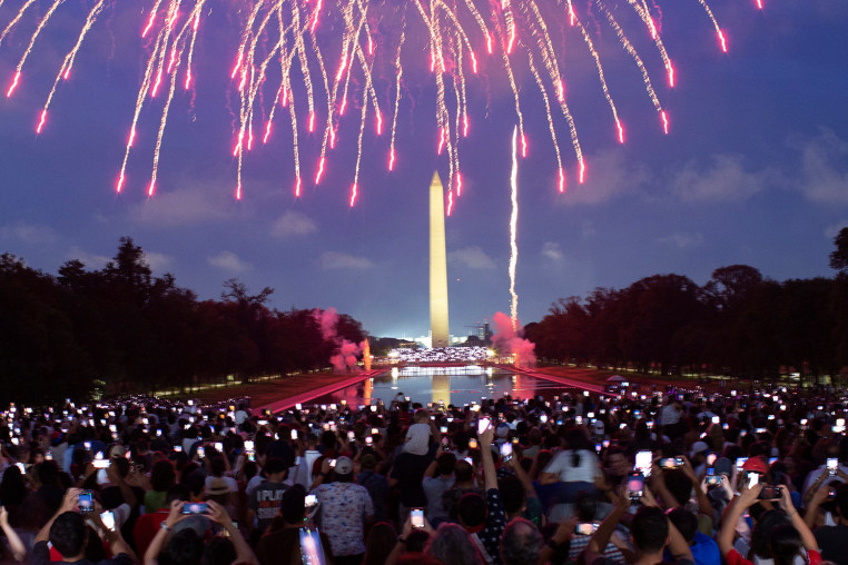 Attendees watch the Independence Day fireworks display along