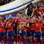 Spain's Alvaro Morata holds the trophy as he celebrates with his teammates after winning the final match between Spain and England at the Euro 2024 soccer tournament in Berlin, Germany, Sunday, July 14, 2024. Spain won 2-1. (AP Photo/Frank Augstein)