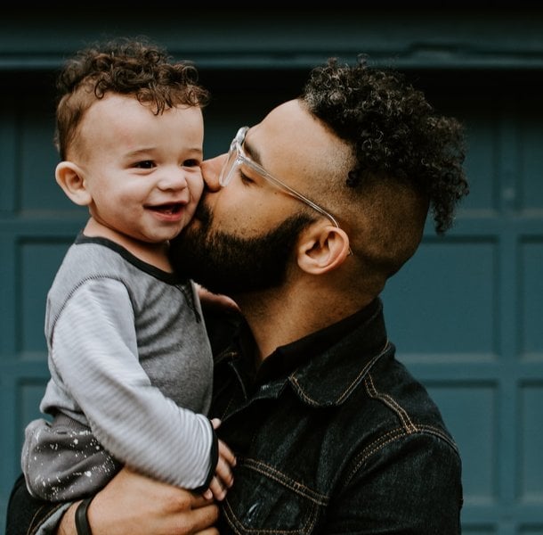 Father kissing toddler