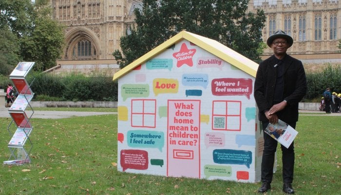 Ronnie Archer Morgan standing outside Houses of Parliment for children in care campaign