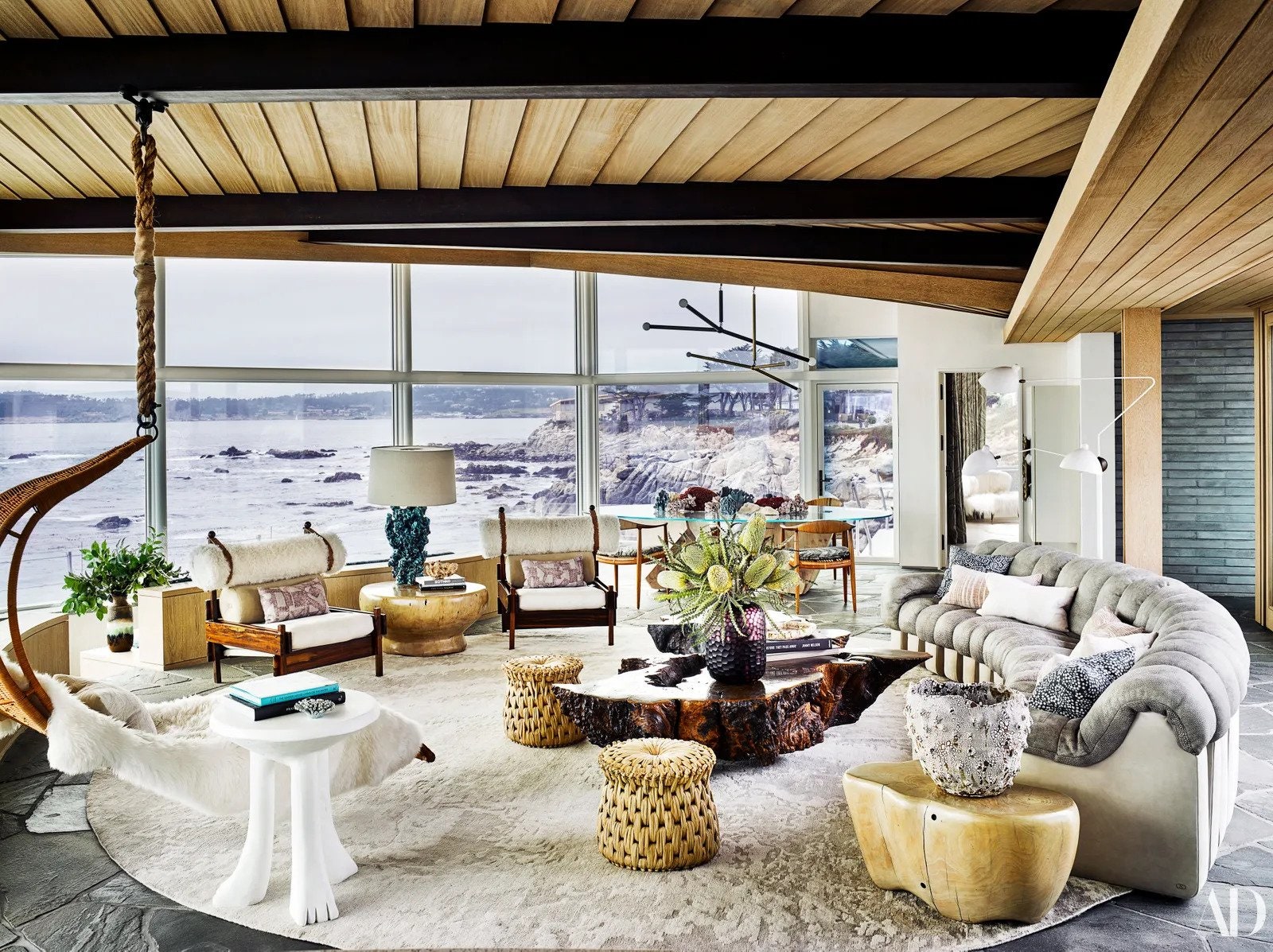 inside a circular room with views of the sea beyond