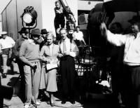 STAND-IN, front from left: director Tay Garnett, visitor Joan Bennett, Leslie Howard on set, 1937