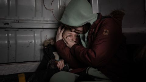 A woman is comforted inside a van during the evacuation of Irpin, a city north of Kyiv under attack by Russian artillery, March 5, 2022. Villages north of Kyiv have been under attack by Russian artillery since the early days. of the invasion.