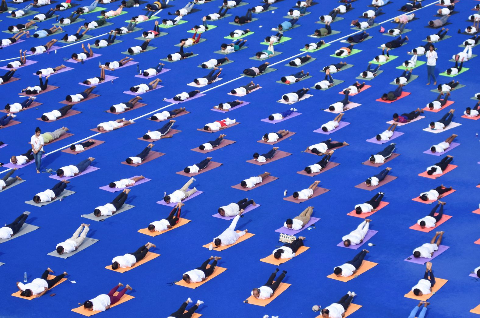 People perform yoga at Kalinga Stadium in Bhubaneswar, India, on Friday, June 21. It was the International Day of Yoga.