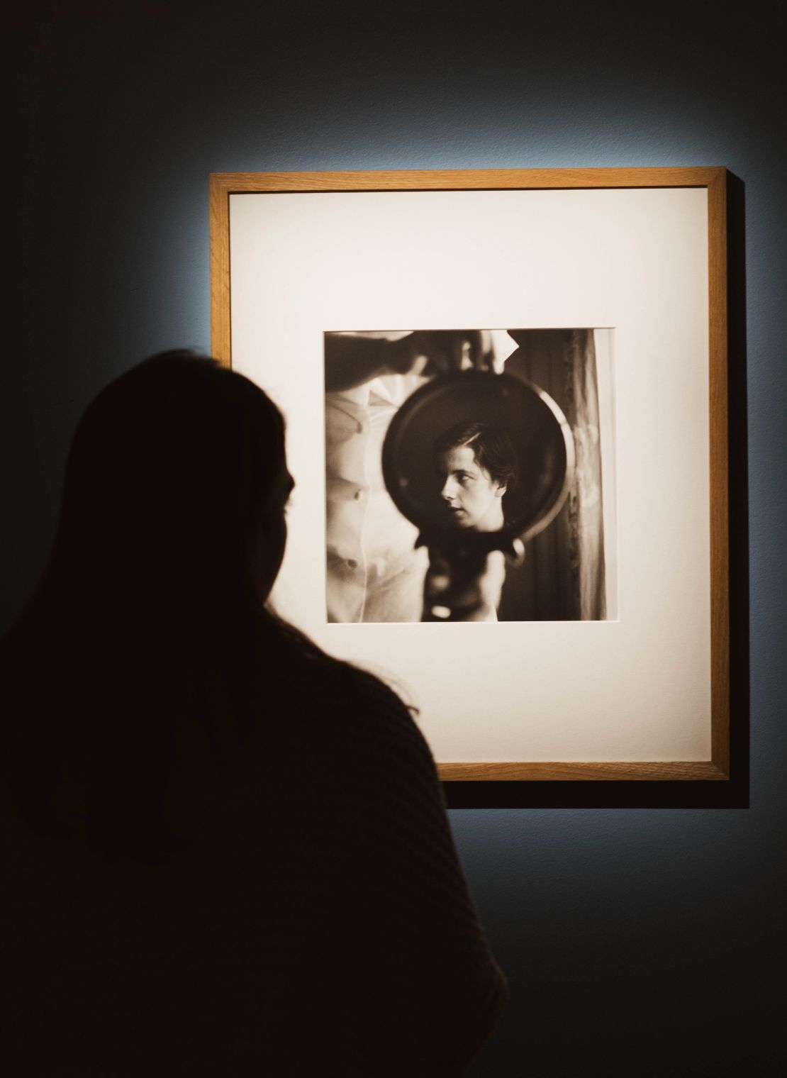 In a self-portrait featured in “Vivian Maier Unseen Work," the photographer lenses herself in profile, reflected in a hand mirror.