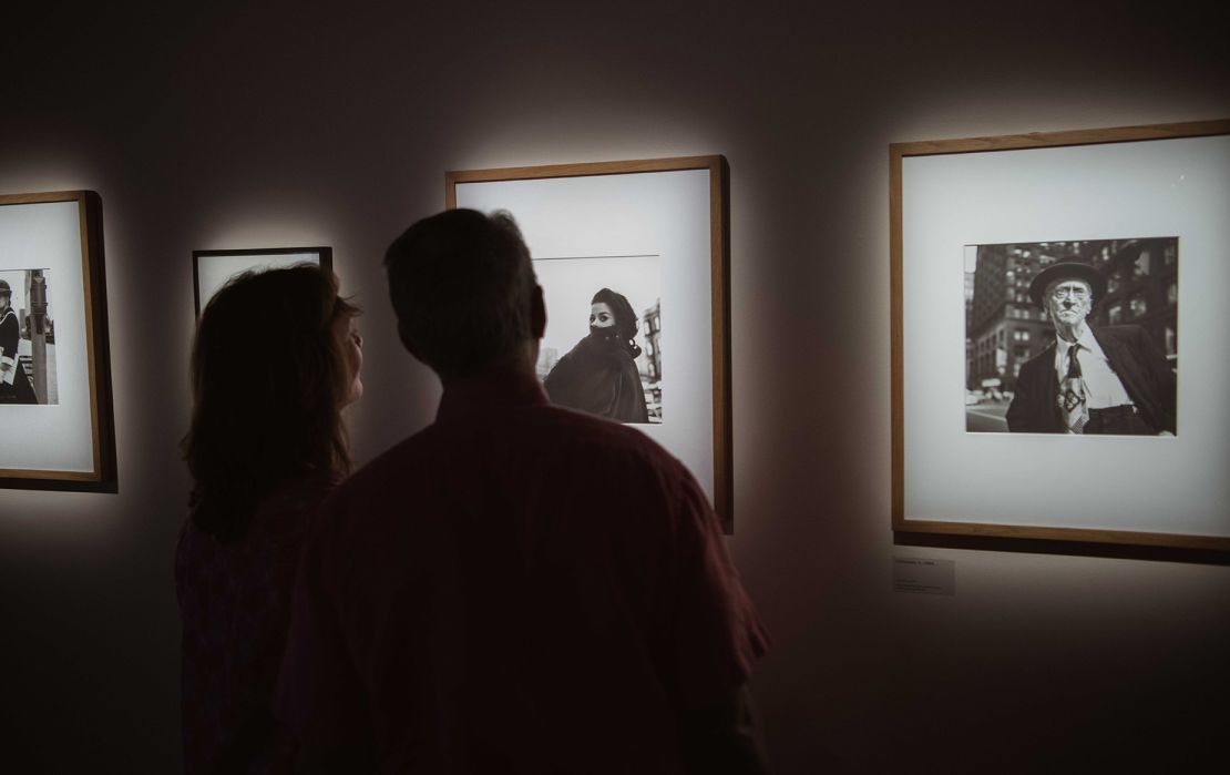 Visitors take in photographs on display at Fotografiska's “Vivian Maier Unseen Work” in New York.