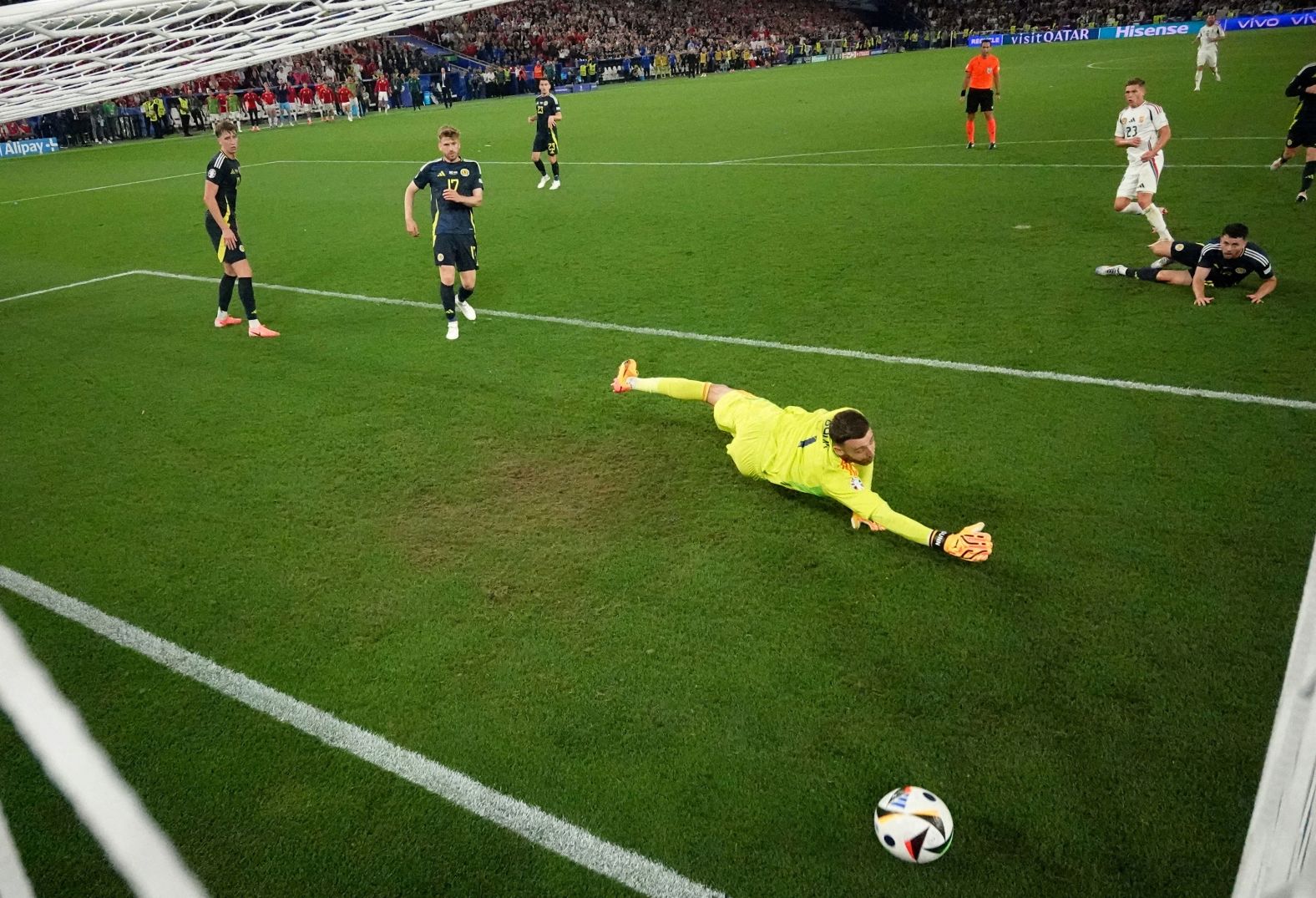 Hungary’s Kevin Csoboth, in white, scores a goal against Scotland during their Euro 2024 match on Sunday, June 23. The goal came late into second-half stoppage time and gave Hungary a 1-0 victory.