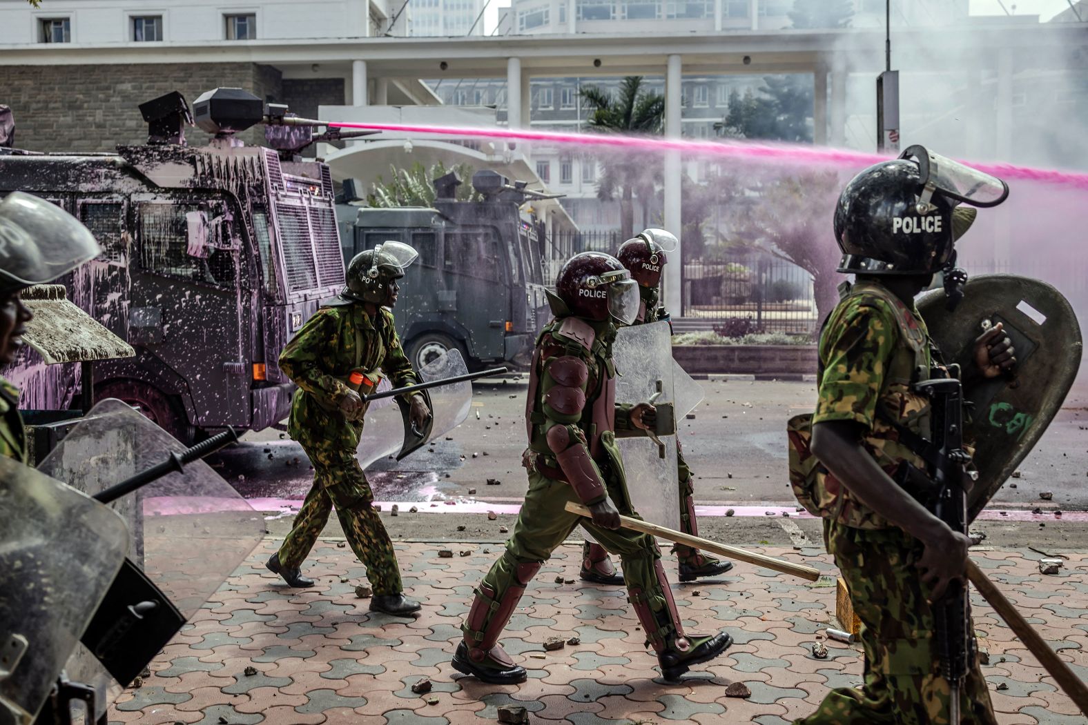 Police officers move in formation next to water cannon trucks as they clash with protesters in Nairobi, Kenya, on Tuesday, June 25. <a href="https://www.cnn.com/2024/06/27/africa/kenya-rocked-by-fresh-protests-intl/index.html">A fresh wave of demonstrations swept the country on Thursday</a> despite President William Ruto’s U-turn on controversial tax plans.