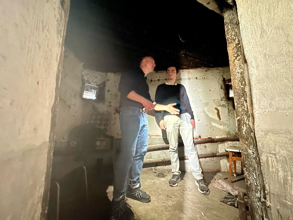 Guide Svitozar Moiseiv and tourist Jean-Baptiste Laborde inside a building that was part of a Soviet army defense fortification during World War II and later became a shelter where a family from the Kyiv suburbs hid from Russian shelling.