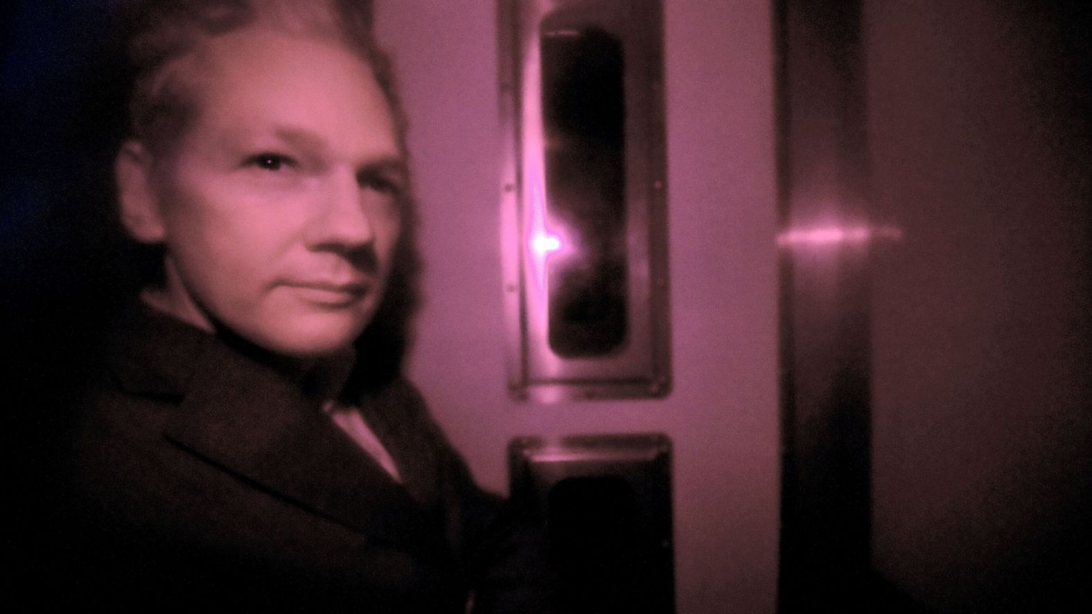 Assange sits behind the tinted window of a police vehicle in London on December 14, 2010. Assange had turned himself in to London authorities on December 7 and was released on bail and put on house arrest on December 16. In February 2011, a judge ruled in support of Assange's extradition to Sweden. Assange's lawyers filed an appeal.