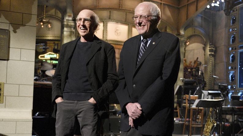 Comedian Larry David and Sanders <a href="http://money.cnn.com/2016/02/07/media/bernie-sanders-larry-david-saturday-night-lvie/" target="_blank">appear together on "Saturday Night Live"</a> in February 2016. David had played Sanders in a series of sketches throughout the campaign season.