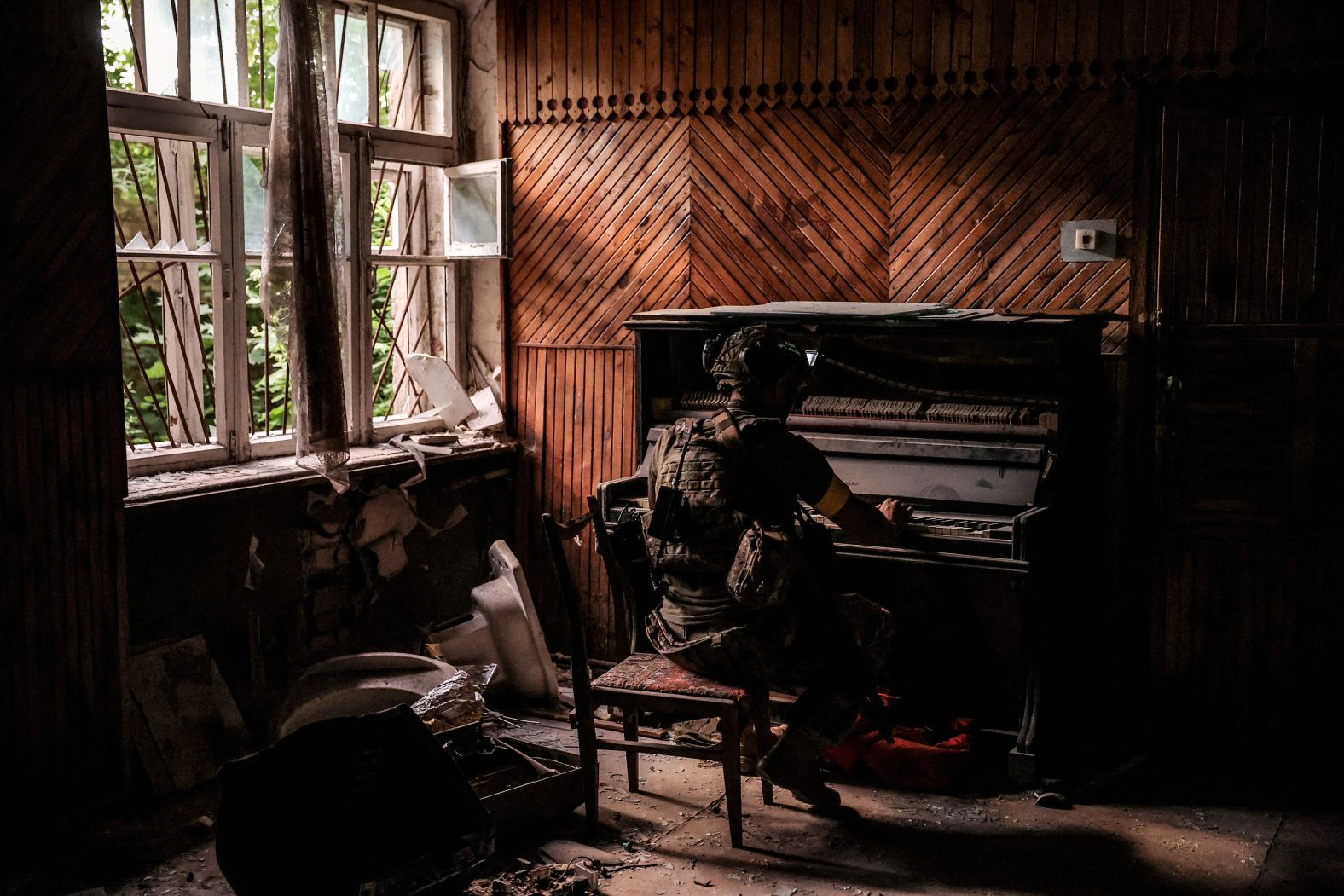 A Ukrainian serviceman plays a piano inside a damaged building in Chasiv Yar, Ukraine, near the front lines of the country’s war with Russia, on Tuesday, June 25.