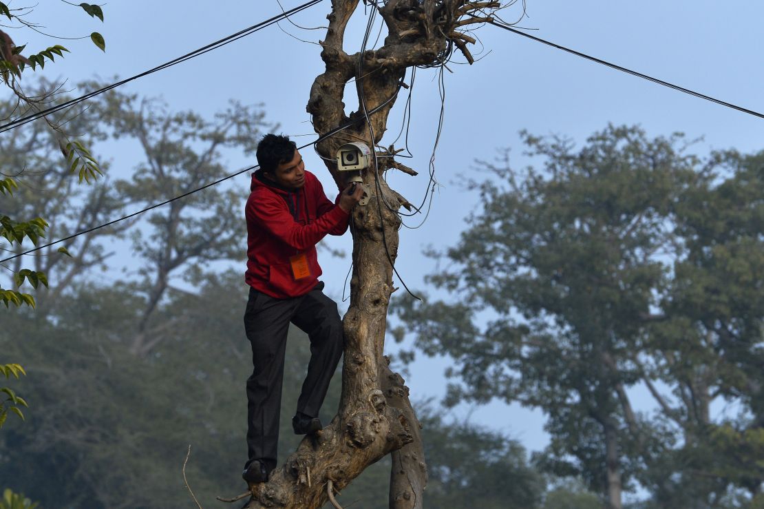 An Indian technician checks the CCTV camera at the roadside near the Presidential Palace as preparations for the nation's Republic Day parade take place in New Delhi.