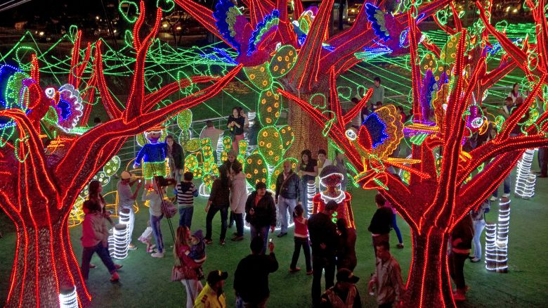 People attend the Christmas lights illumination in the Medellin river on December 1, 2012 in Medellin, Antioquia department, Colombia.