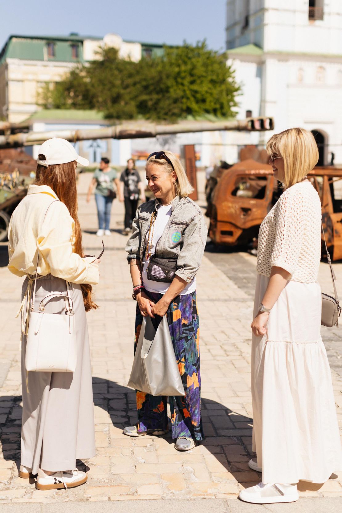 Austrian volunteer Petra Schröckeneder listening to guide Yulia Bevzenko during a tour of Kyiv's city center.