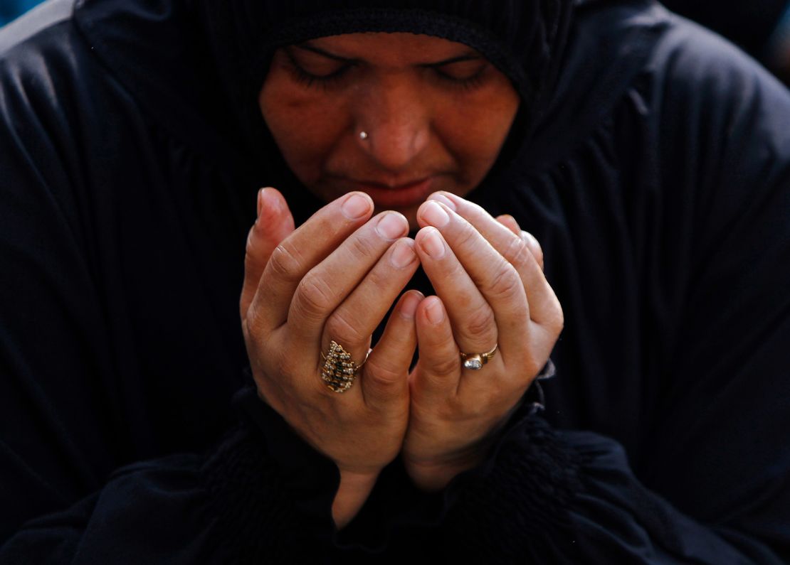 A Muslim woman offers Eid al-Adha prayers at a school ground in Chennai, India, on October 16, 2013. Muslims around the world celebrate Eid al-Adha by the sacrificial killing of sheep, goats, cows and camels to commemorate Prophet Abraham's willingness to sacrifice his son Ismail on God's command.