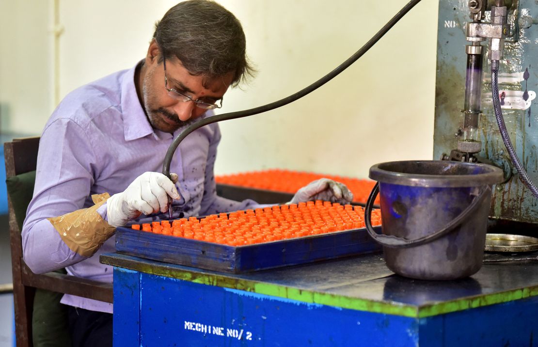 A worker fills vials of the indelible ink that is used during elections to prevent duplication of voting, at the government-run Mysore Paints and Varnish company in Mysuru, India.