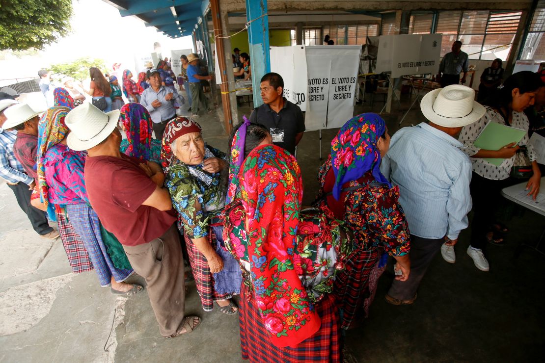 People wait to vote in San Bartolome Quialana, Mexico, on June 2, 2024.