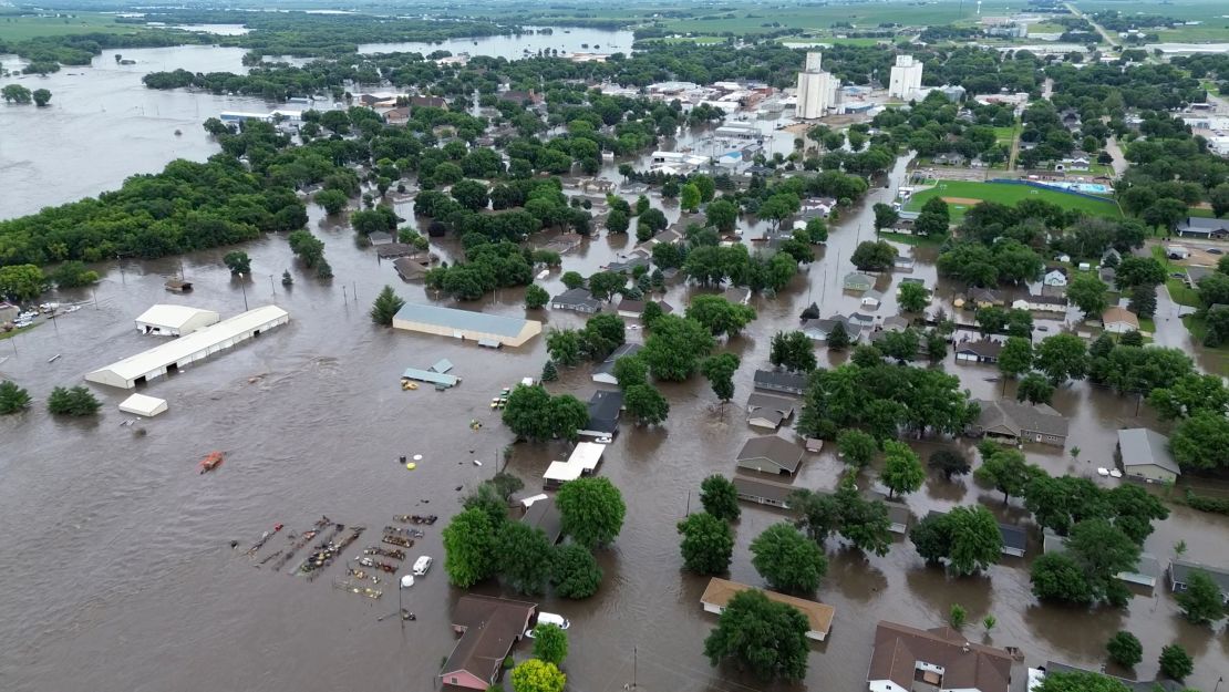 Iowa Gov. Kim Reynolds flew over the flood-ravaged state Saturday with federal officials. Reynolds said she is working with federal agencies on recovery efforts.