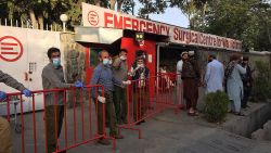 Afghan medical staff members stand at the entrance of a hospital as they wait to receive the victims of an explosion in Kabul on October 3, 2021. (Photo by Hoshang HASHIMI / AFP) (Photo by HOSHANG HASHIMI/AFP via Getty Images)