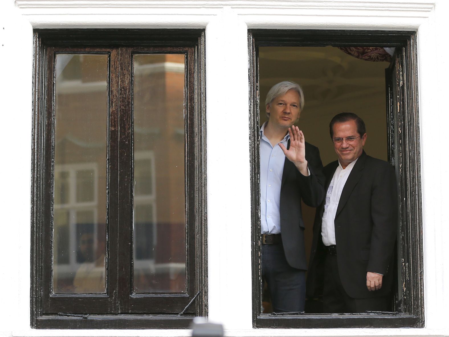 Assange appears with Ecuadorian Foreign Minister Ricardo Patino on the balcony of the embassy in June 2013.