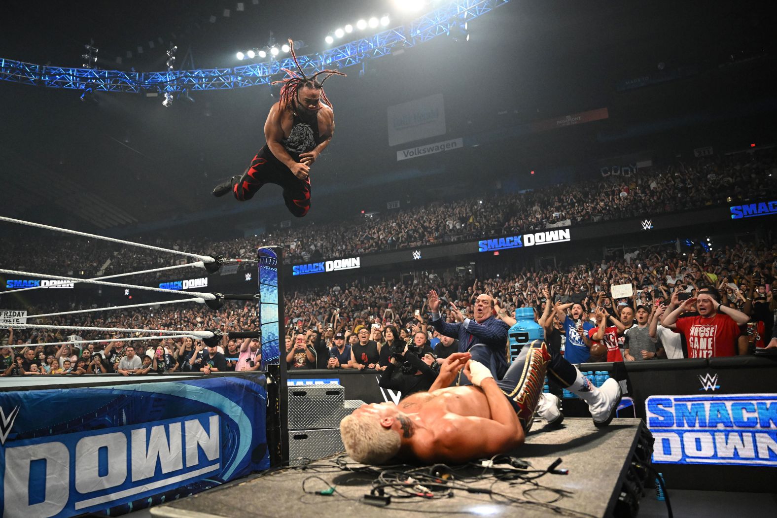 Jacob Fatu jumps off the top rope and flies toward WWE Undisputed Champion Cody Rhodes during an event in Rosemont, Illinois, on Friday, June 21.