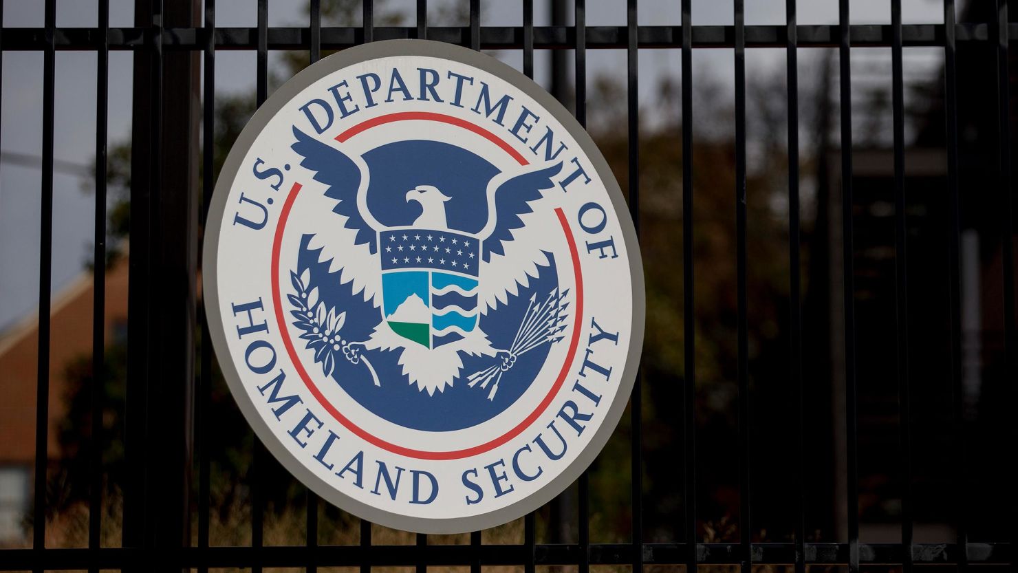 The U.S. Department of Homeland Security (DHS) seal hangs on a fence at the agency's headquarters in Washington, D.C., U.S., on Thursday, Dec. 11, 2014.