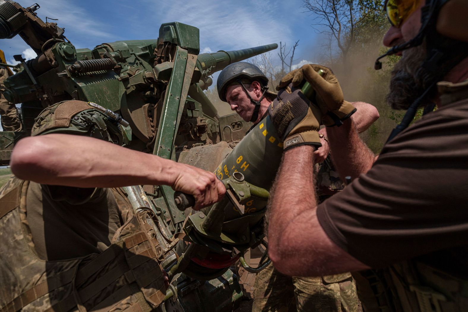 Ukrainian soldiers load a shell into a self-propelled howitzer before firing toward Russian positions in Ukraine’s Donetsk region on Monday, June 24.