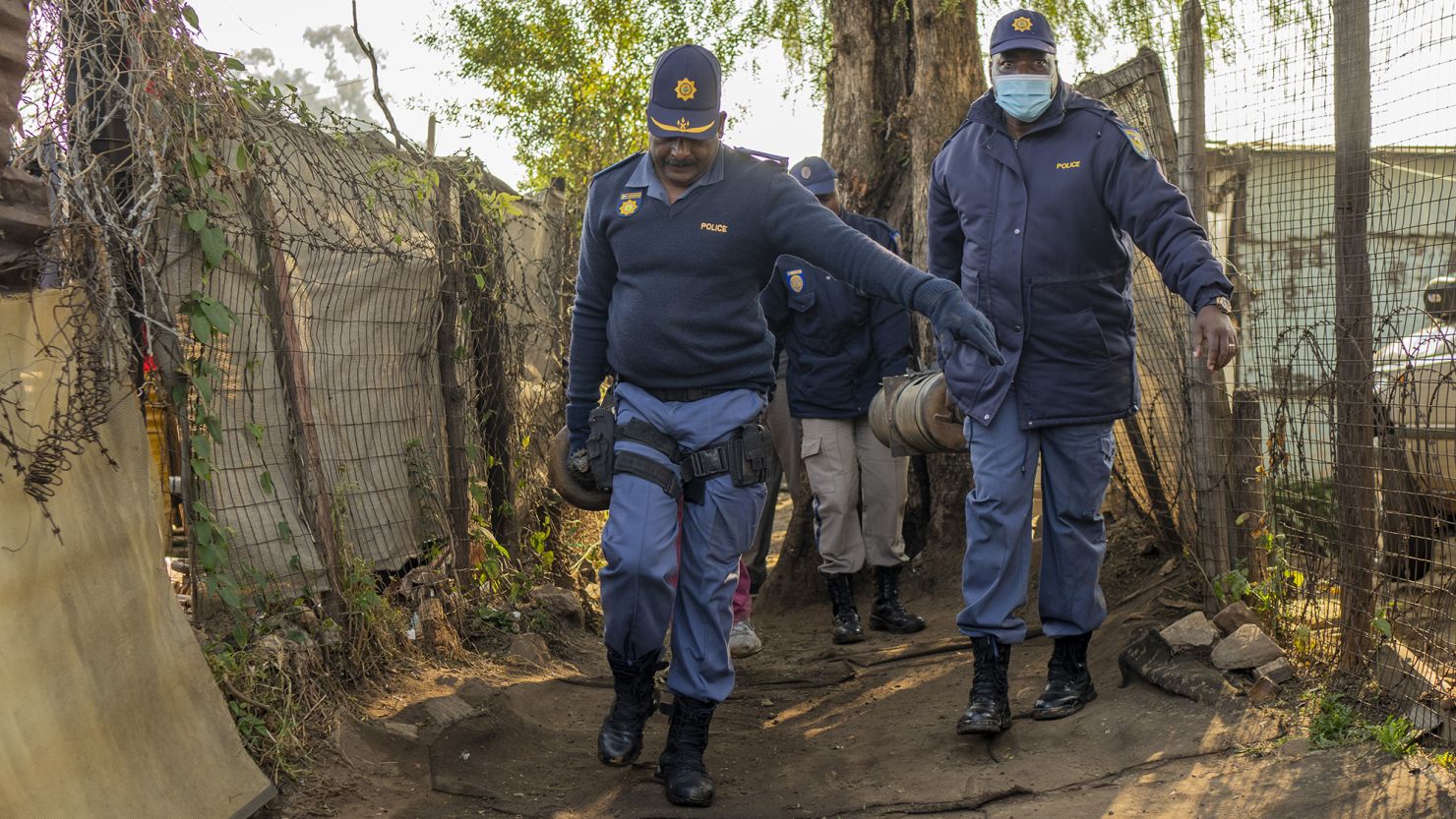 South African police officers remove gas cylinders used by illegal gold miners in the Angelo Informal Settlement in Boksburg, South Africa, Thursday July 6, 2023. 