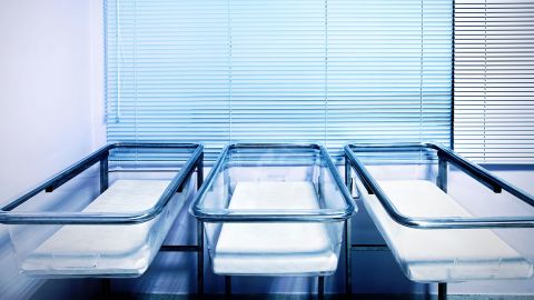 Baby cribs at a maternity ward. Low birth rate and fertility concept.