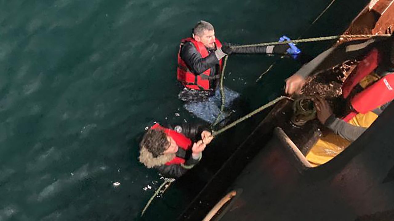 In the early hours of December 14, 2022, 39 migrants were saved from a collapsed rubber boat stranded in the middle of the English Channel between the United Kingdom and France. Images from the night of the rescue show people being hauled out of the water using ropes attached to the fishing boat. A British RNLI lifeboat is the first official responder on the scene and drops a string of life rings to assist people.